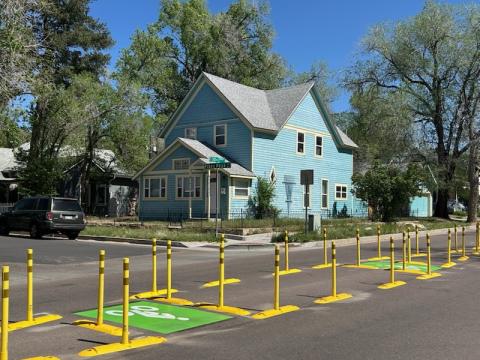 Another angle from the side of the bike-permeable median on Pikes Peak Ave./30th St. The street signs are visible.