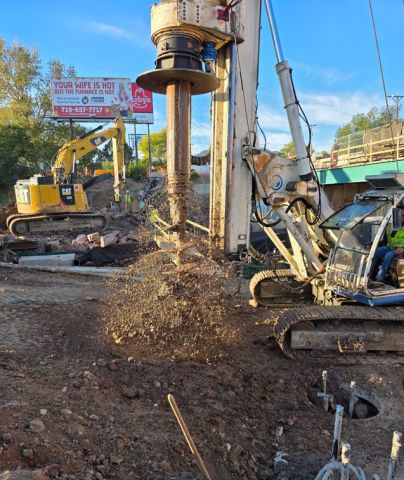Dirt flies from an auger during cleaning after drilling bridge foundation piers Oct. 8, 2025.