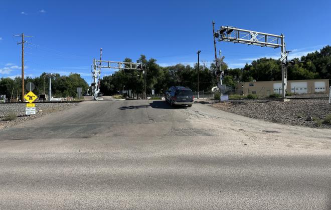 A SUV driving up the steep approach to the Royer Street railroad crossing north of Las Vegas Street.