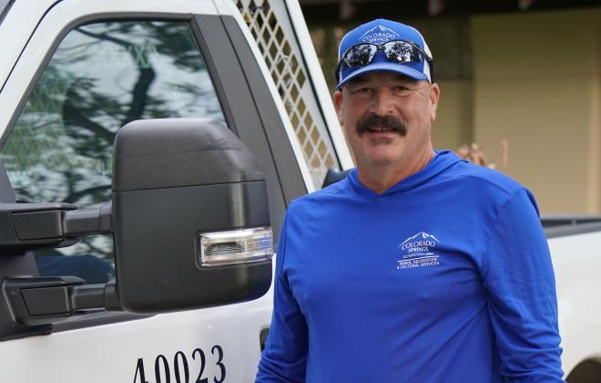 Photo of Steve Schreck in front of a PRCS work vehicle.