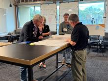 Community members engaging with the community meeting regarding N. Stone Street